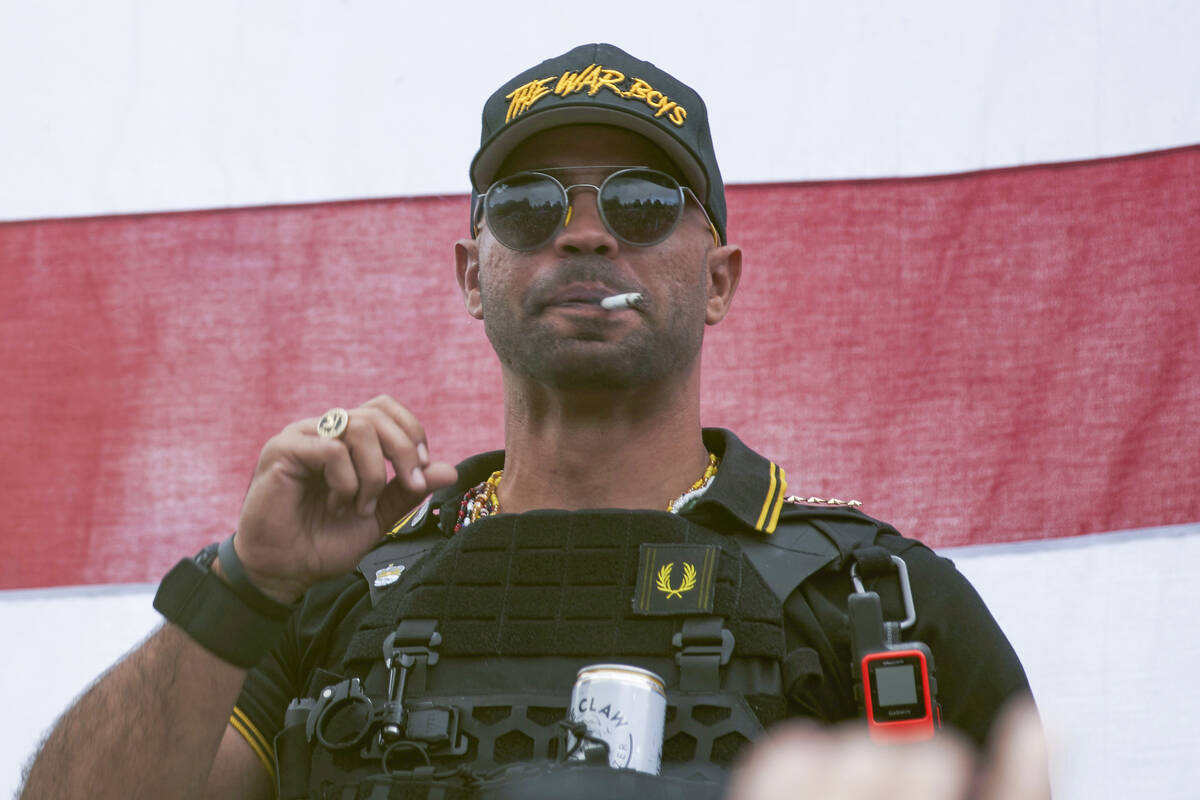 FILE - Proud Boys leader Henry "Enrique" Tarrio wears a hat that says The War Boys du ...