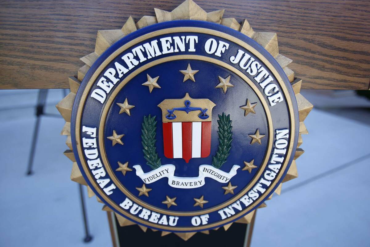 An FBI podium is shown during a press conference outside the main entrance of City Hall in Boul ...