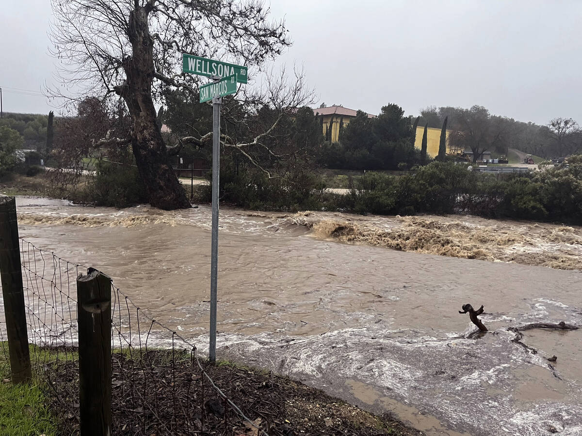 In this photo provided by Neil Collins, floodwaters continue to flow at the intersection of Wel ...