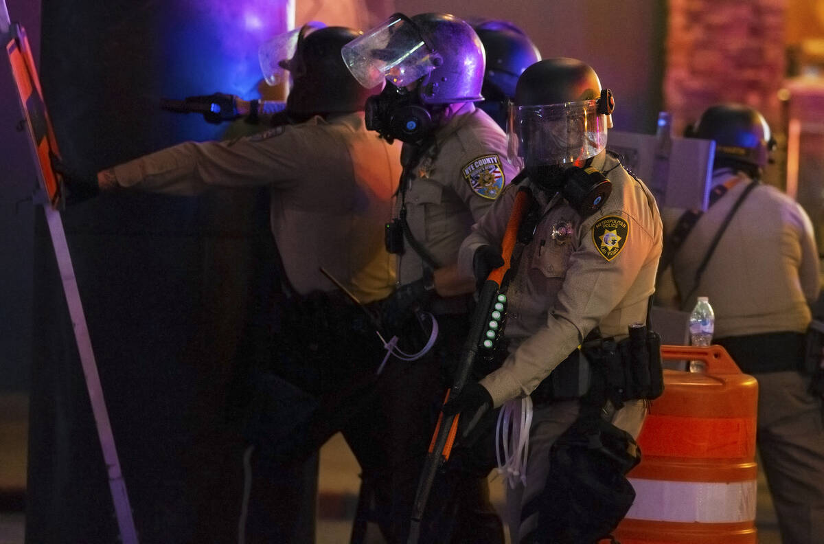 Police take position minutes before firing tear gas and pepper bullets on Fremont Street during ...