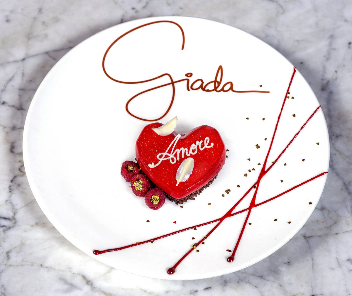 Chocolate Amore with chocolate-chocolate chip cake, caramel panna cotta, raspberry jam and whit ...
