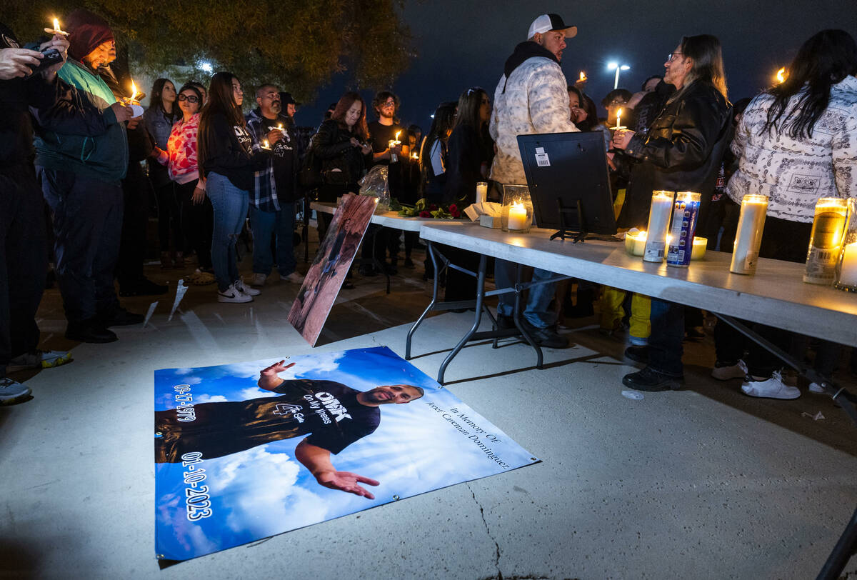 A large banner of Jonet Dominguez is amongst other images on display during a candlelight vigil ...