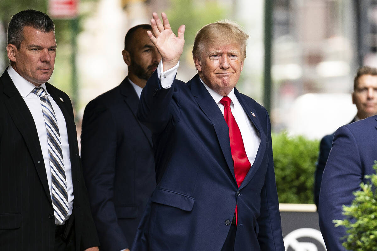 Former President Donald Trump waves as he departs Trump Tower, Wednesday, Aug. 10, 2022, in New ...