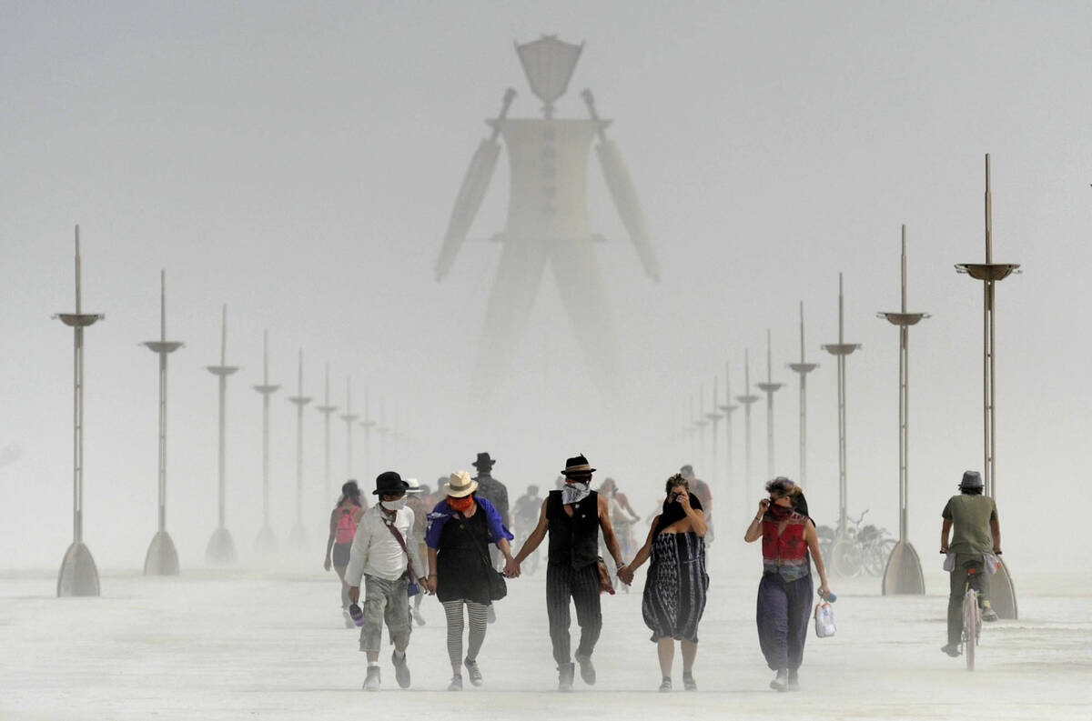 Participants walk through dust at the annual Burning Man event on the Black Rock Desert of Gerl ...