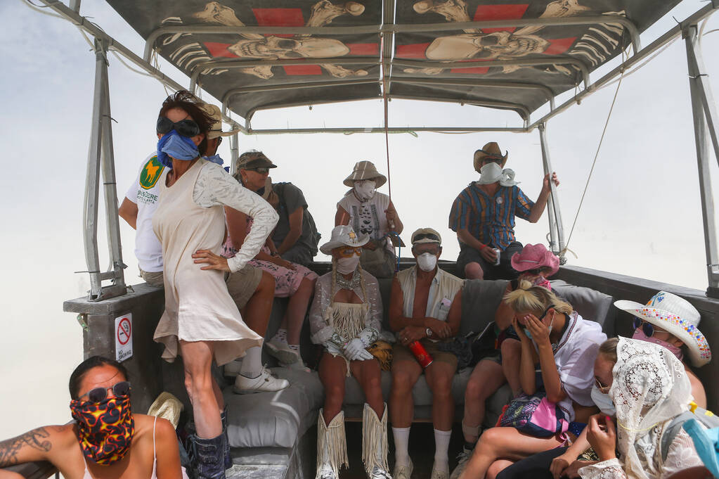 Attendees aboard the USS Nevada art car look on as a dust storm passes through during Burning M ...