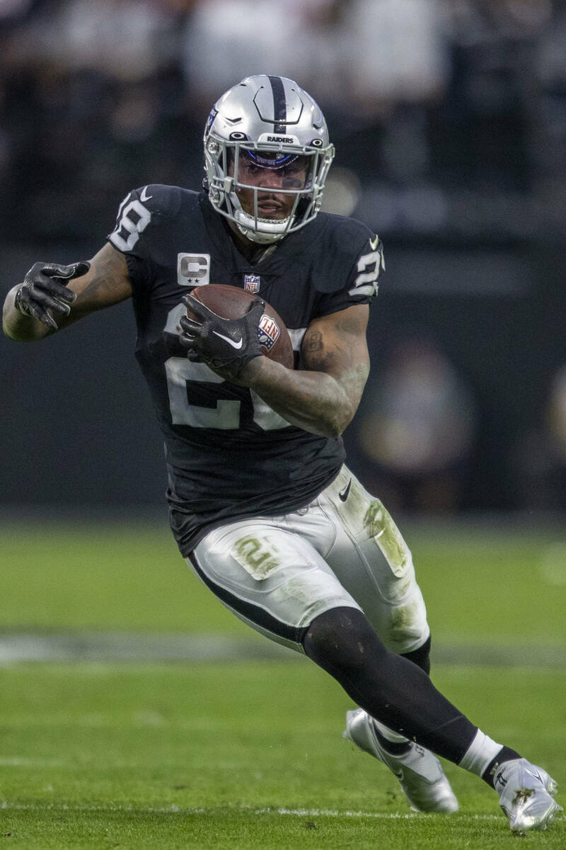 Raiders running back Josh Jacobs (28) runs against the San Francisco 49ers during the first hal ...