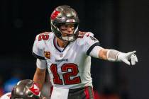 Tampa Bay Buccaneers quarterback Tom Brady (12) points during the first half of an NFL football ...