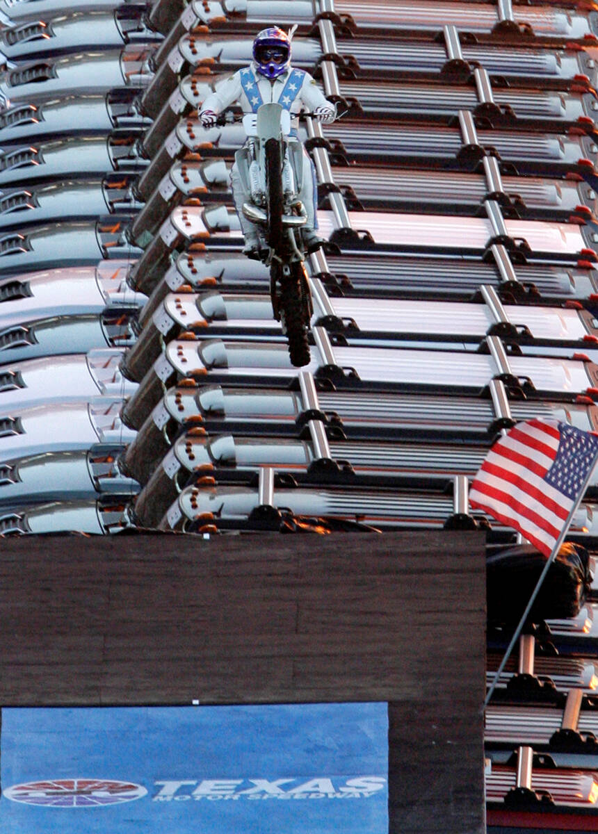 Motorcycle stunt driver Robbie Knievel successfully jumps over 21 Hummers prior to an IRL auto ...