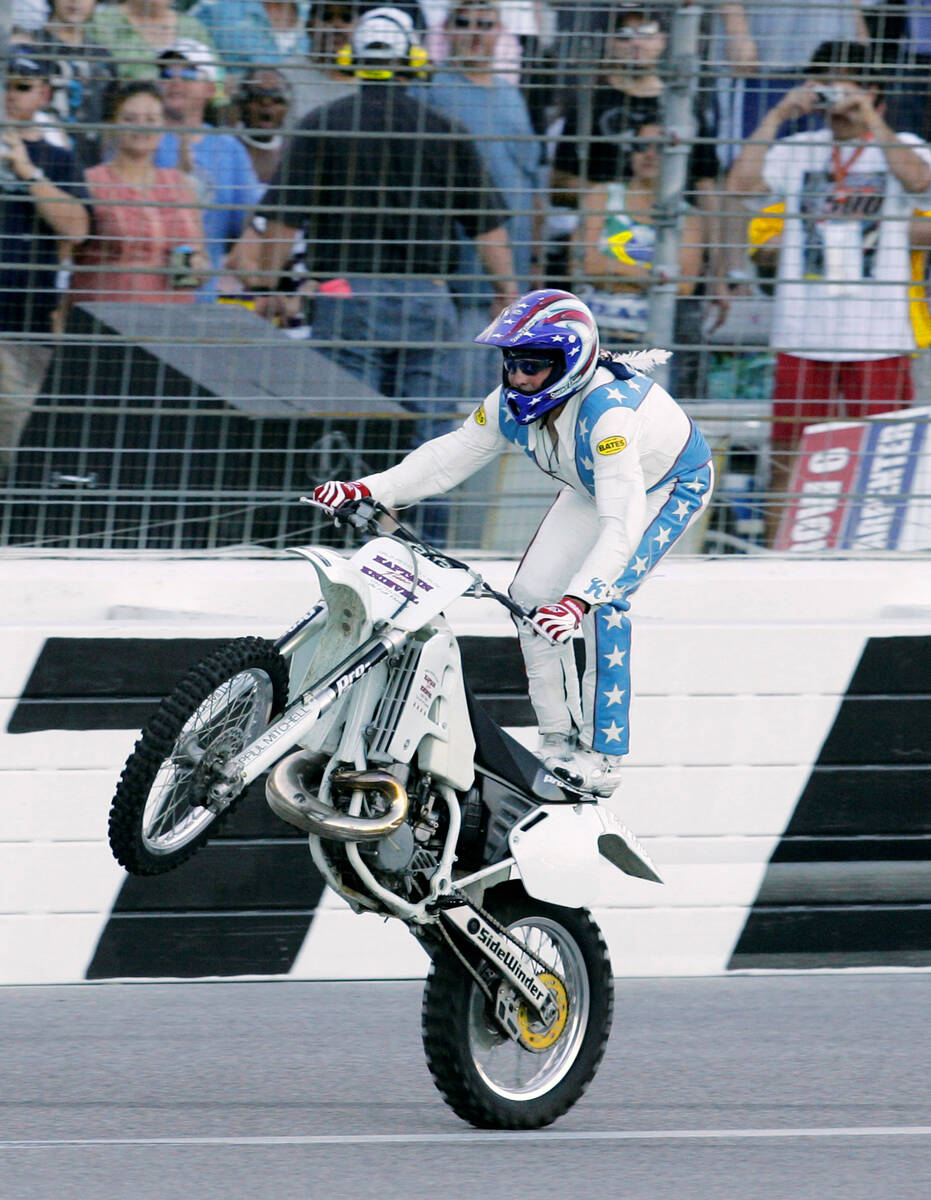 Stunt motorcycle driver Robbie Knievel performs a stunt for fans prior to making his jump over ...