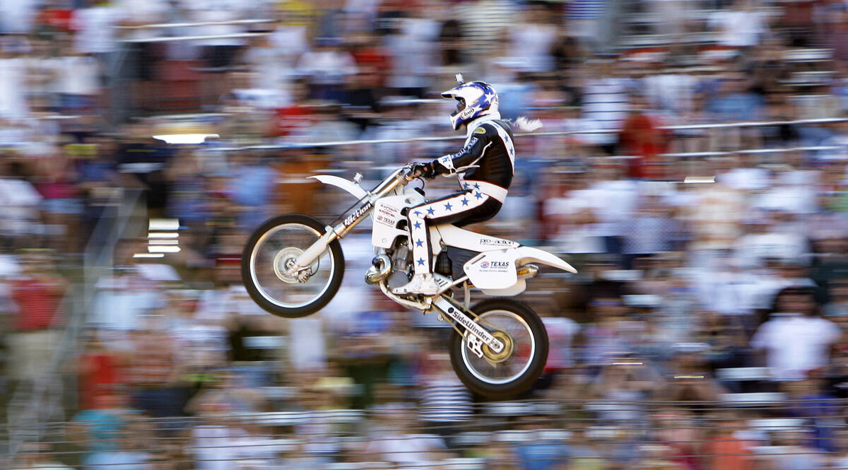 Kaptain Robbie Knievel flies on his motorcycle for a jump before the start of the IRL Firestone ...