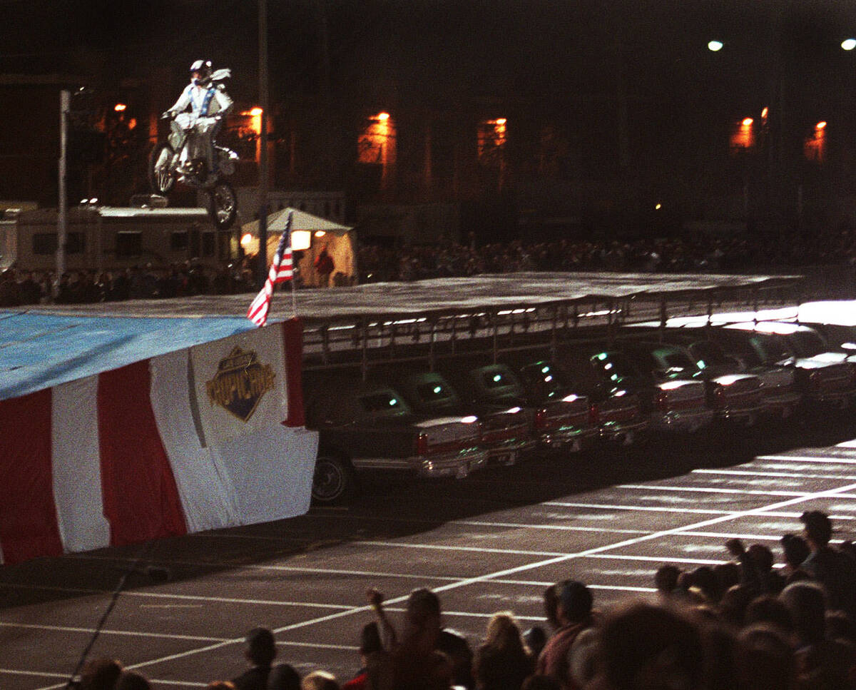 Robbie Knievel successfully lands after jumping his motorcycle over 30 limousines at the Tropic ...