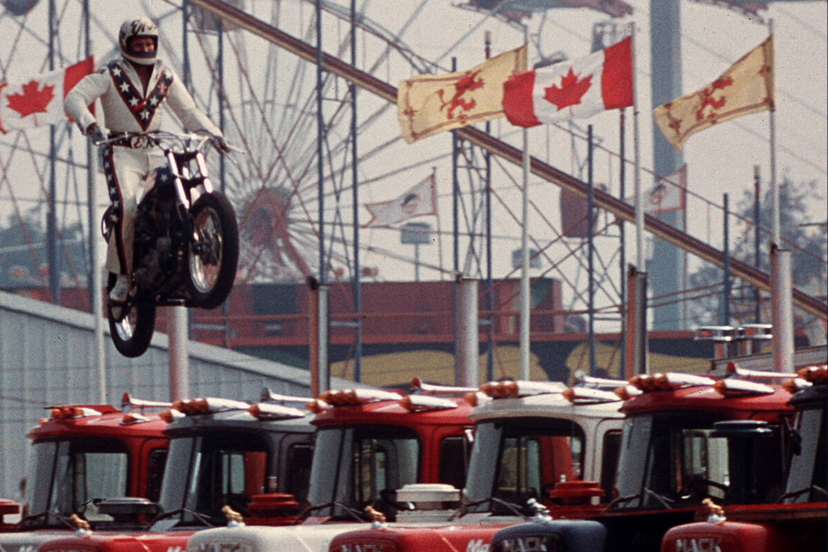 FILE - In this Aug. 20, 1974, file photo Daredevil motorcyclist Evel Knievel sails over 7 Mack ...