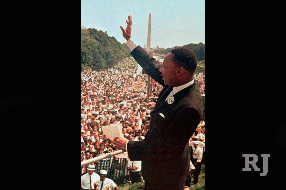 In this Aug. 28, 1963, file photo, the Rev. Dr. Martin Luther King, Jr. acknowledges the crowd ...