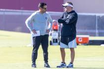 Raiders general manager Dave Ziegler, left, and head coach Josh McDaniels meet during practice ...