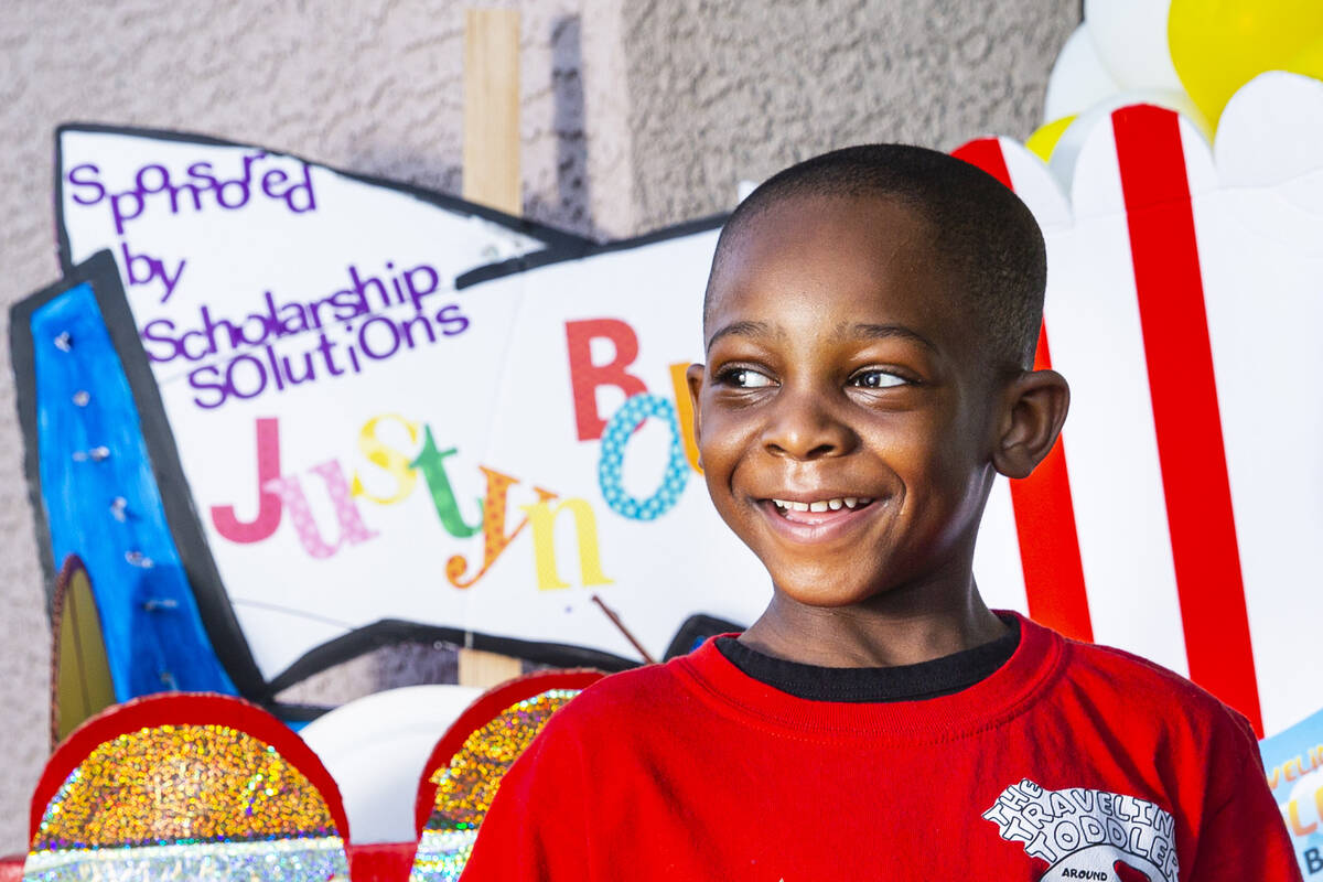 Five-year-old Justyn Boumah, who led a read-a-thon fundraiser, poses for a portrait at his home ...