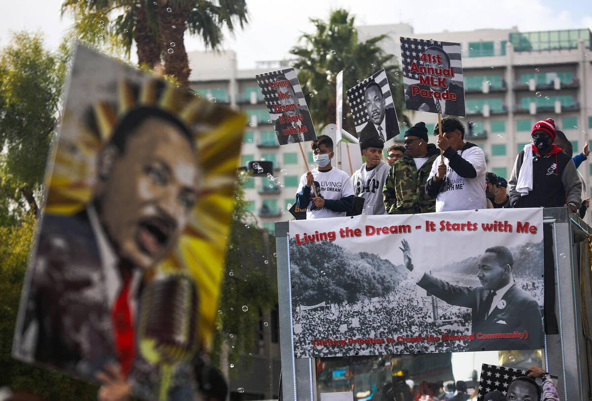 Parade goers ride a float in the 41st annual Martin Luther King Jr. parade in downtown Las Vega ...