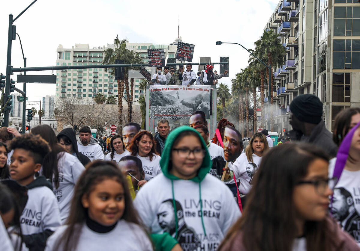 Parade goers walk in the 41st annual Martin Luther King Jr. parade in downtown Las Vegas on Mon ...
