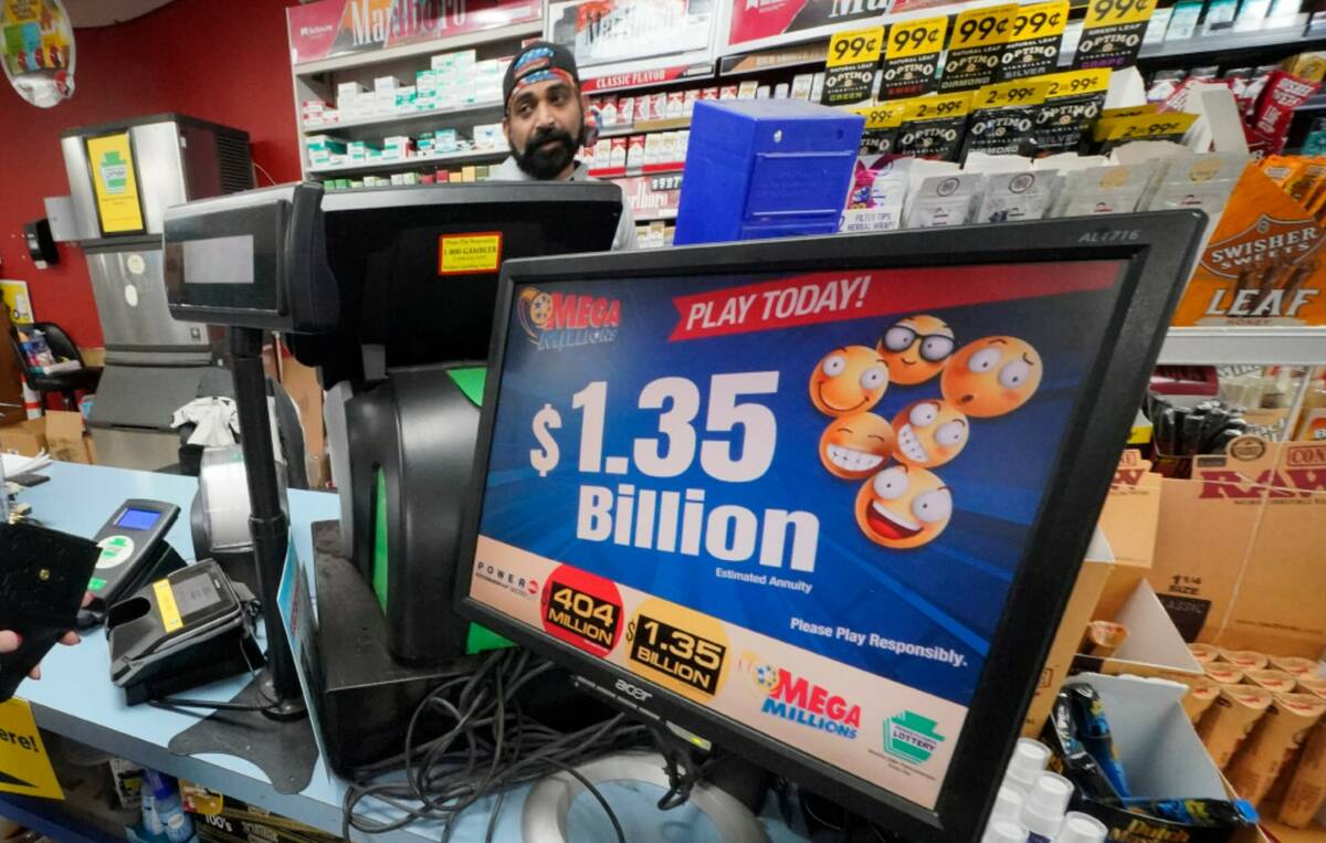 A Mega Million sign displays the estimated jackpot of $1.35 Billion at the Cranberry Super Mini ...