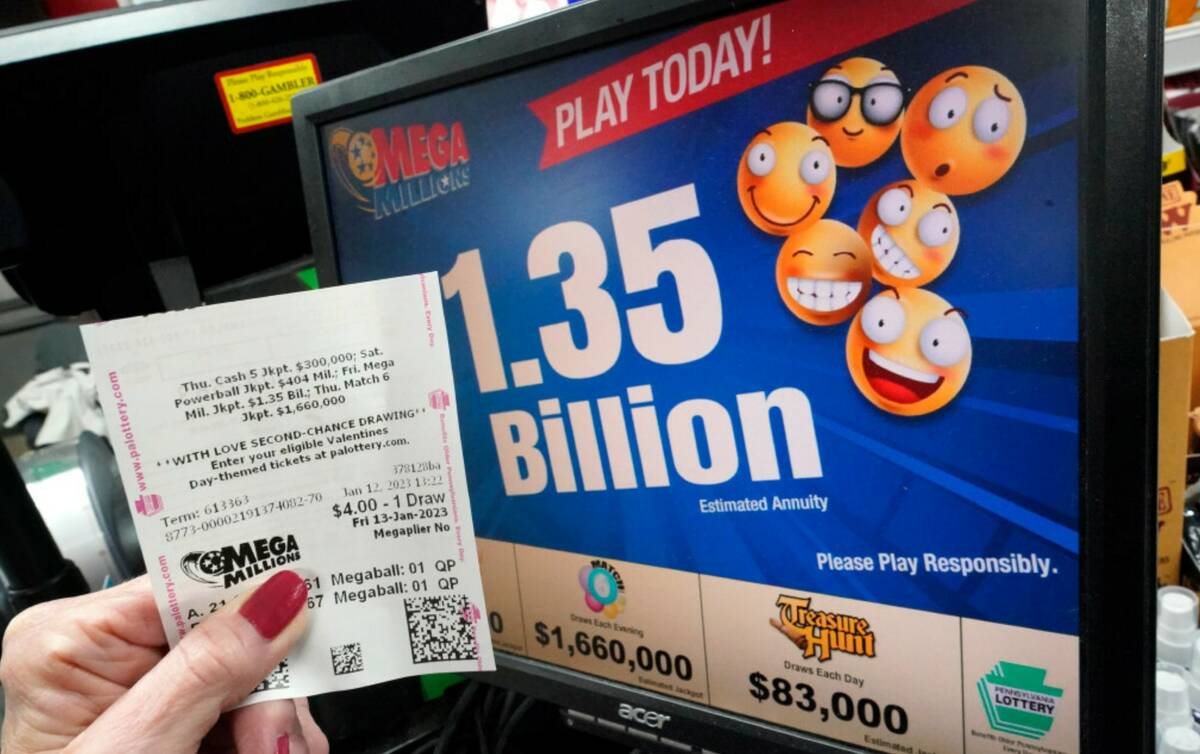 A customer at the Cranberry Super Mini Mart in Cranberry, Pa., shows her Mega Millions ticket o ...