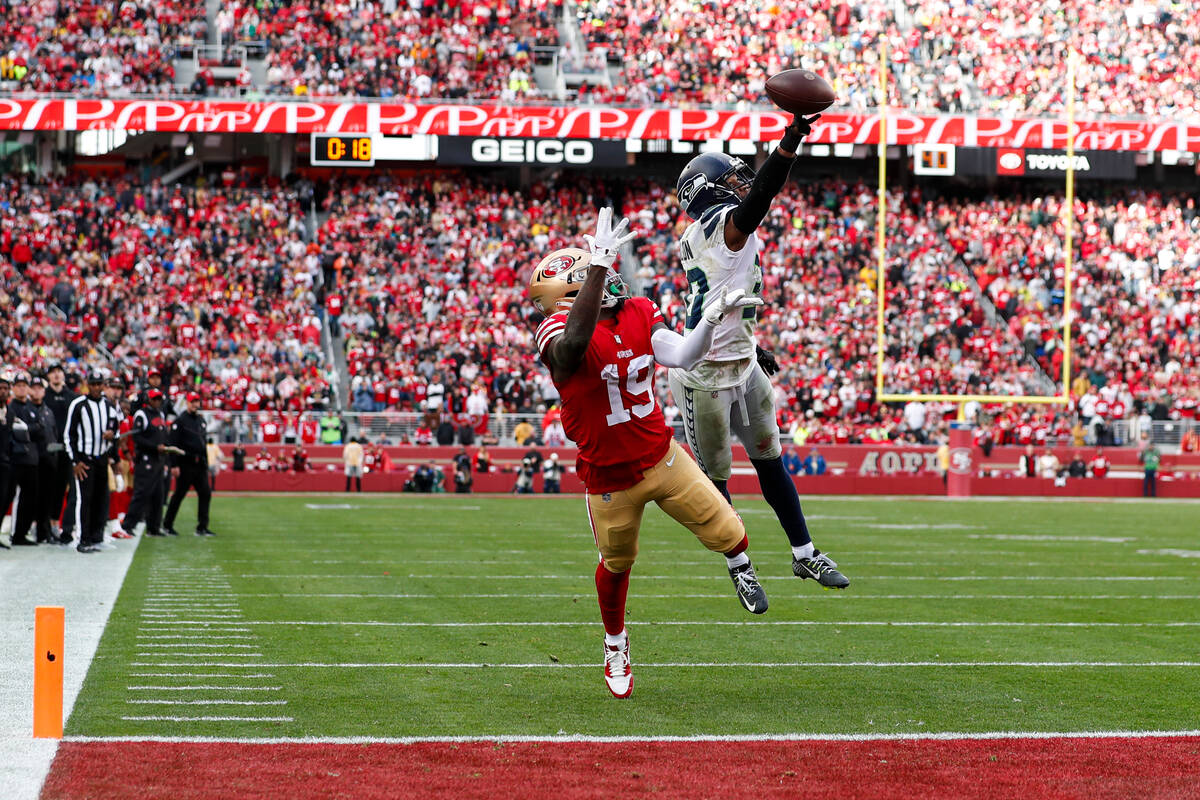Seattle Seahawks cornerback Mike Jackson, right, tips a pass intended for San Francisco 49ers w ...