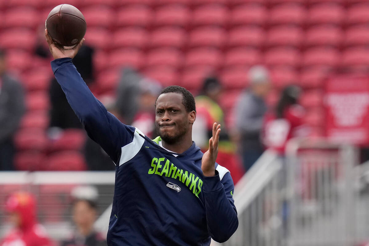 Seattle Seahawks quarterback Geno Smith warms up before an NFL wild card playoff football game ...