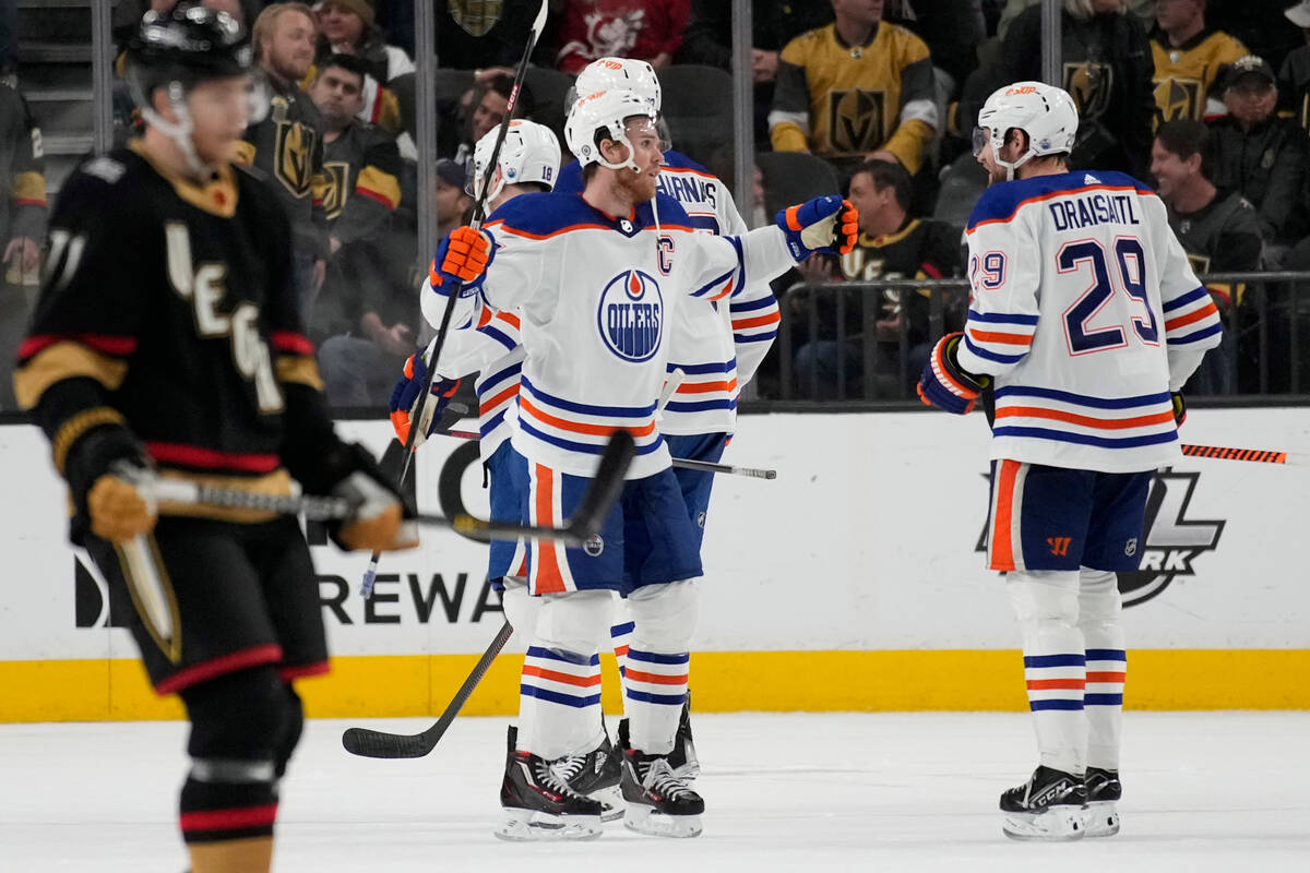 Edmonton Oilers center Connor McDavid, center, celebrates with teammates after defeating the Ve ...