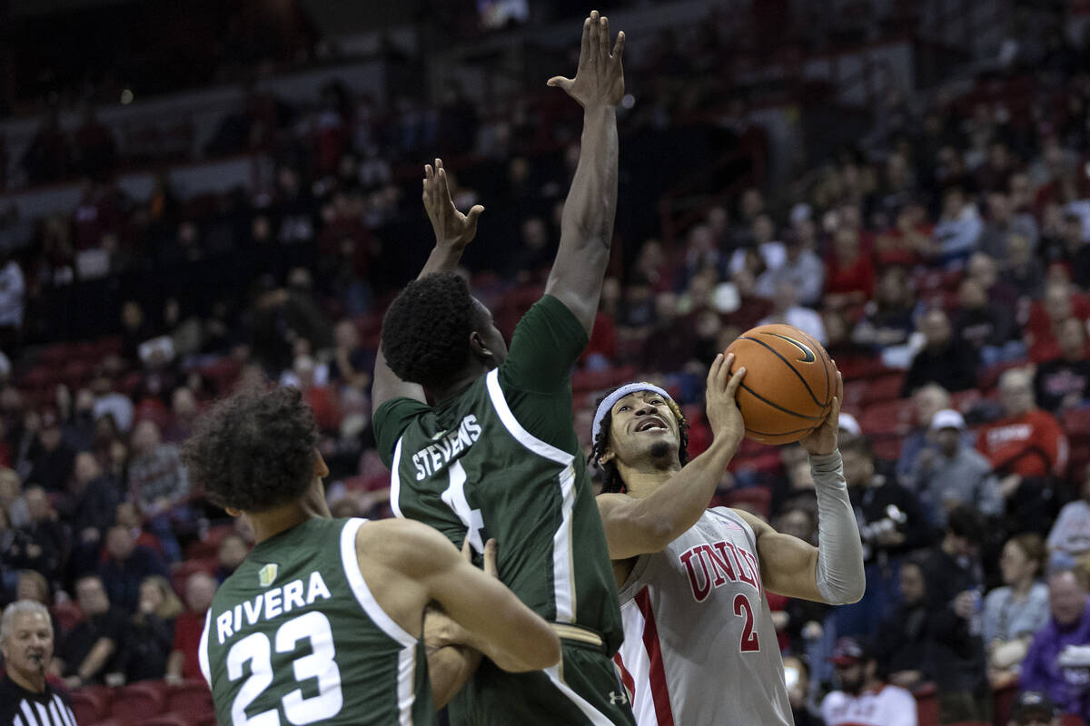 UNLV Rebels guard Justin Webster (2) drives to shoot around Colorado State Rams guard Isaiah St ...