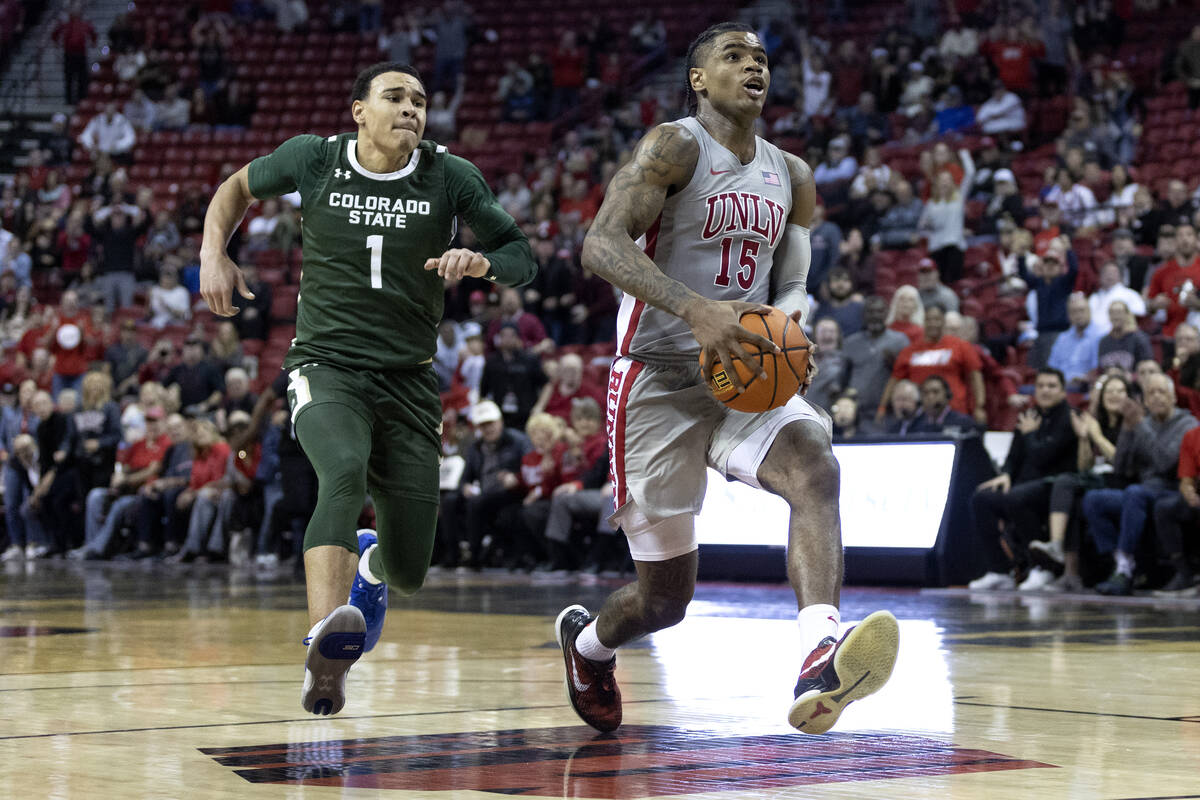 UNLV Rebels guard Luis Rodriguez (15) drives toward the hoop followed by Colorado State Rams gu ...