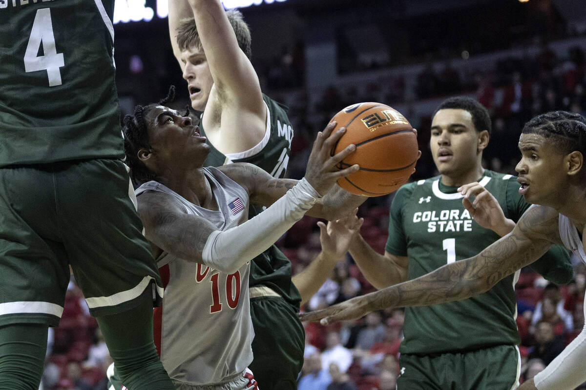 UNLV Rebels guard Keshon Gilbert (10) shoots against Colorado State Rams players including Colo ...