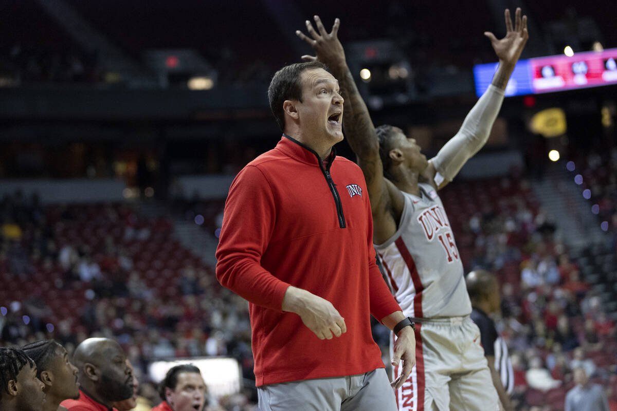 UNLV Rebels head coach Kevin Kruger and guard Luis Rodriguez (15) react to a foul referees call ...