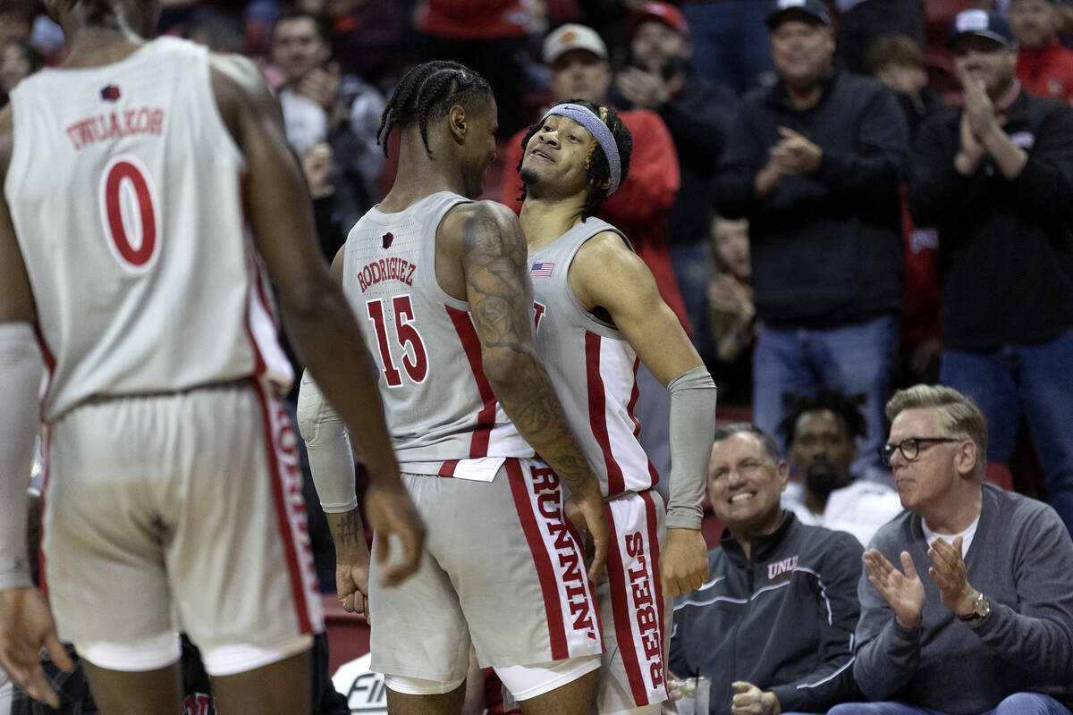 UNLV Rebels guard Justin Webster (2) celebrates with guard Luis Rodriguez (15) after scoring du ...