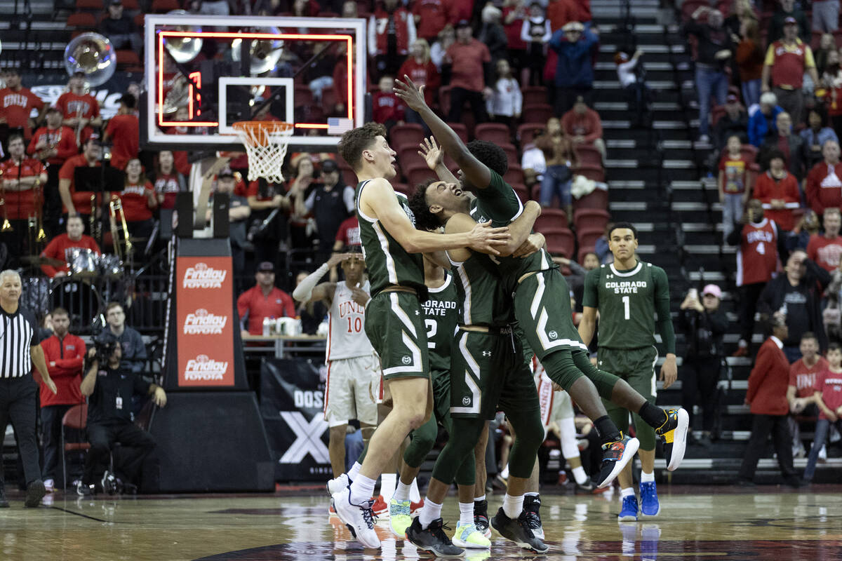 Colorado State Rams guard Isaiah Stevens, right, jumps into the arms of his teammates after sco ...