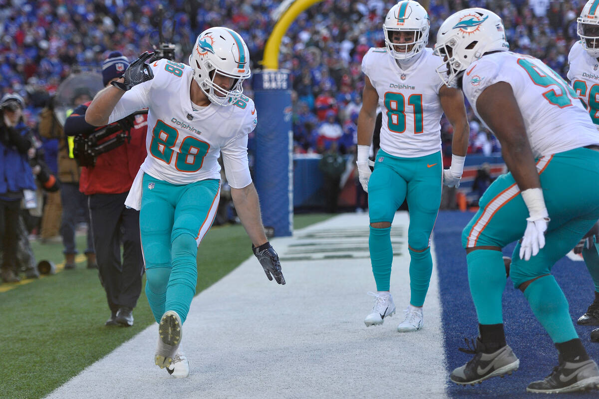Miami Dolphins tight end Mike Gesicki (88), left, celebrates after his touchdown during the fir ...