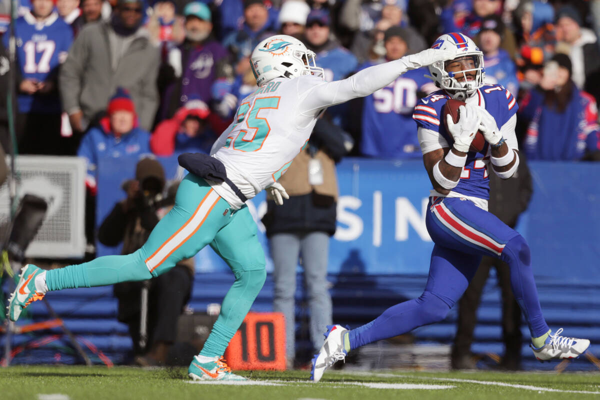 Buffalo Bills wide receiver Stefon Diggs, right, grabs a pass in front of Miami Dolphins corner ...