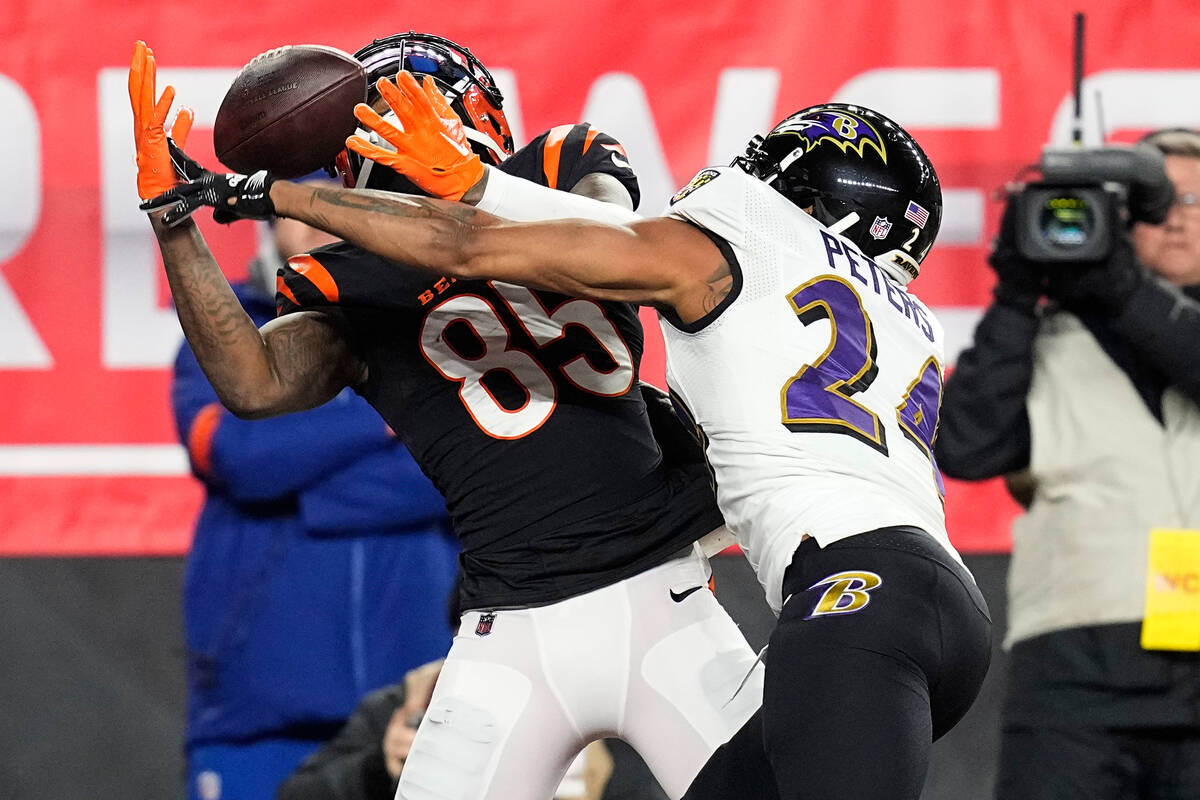 Baltimore Ravens cornerback Marcus Peters (24) breaks up a pass intended for Cincinnati Bengals ...