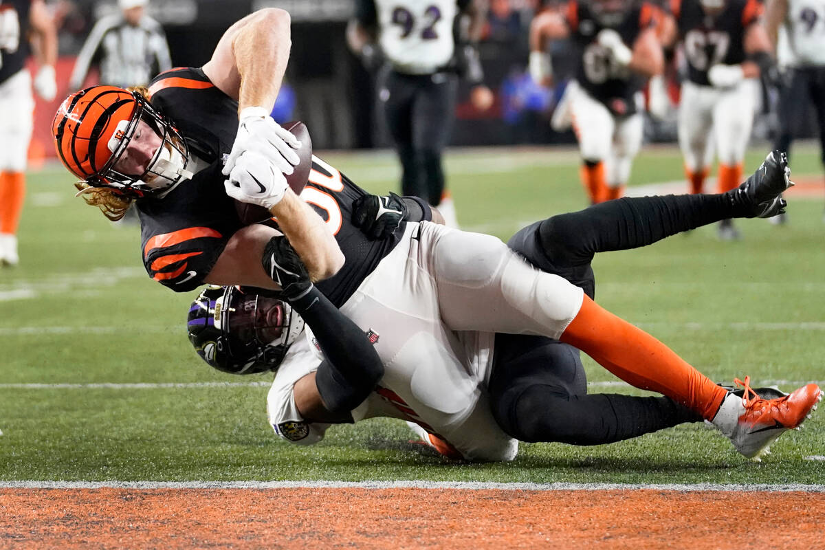 Cincinnati Bengals tight end Hayden Hurst, front, is stopped short of the goal line by Baltimor ...