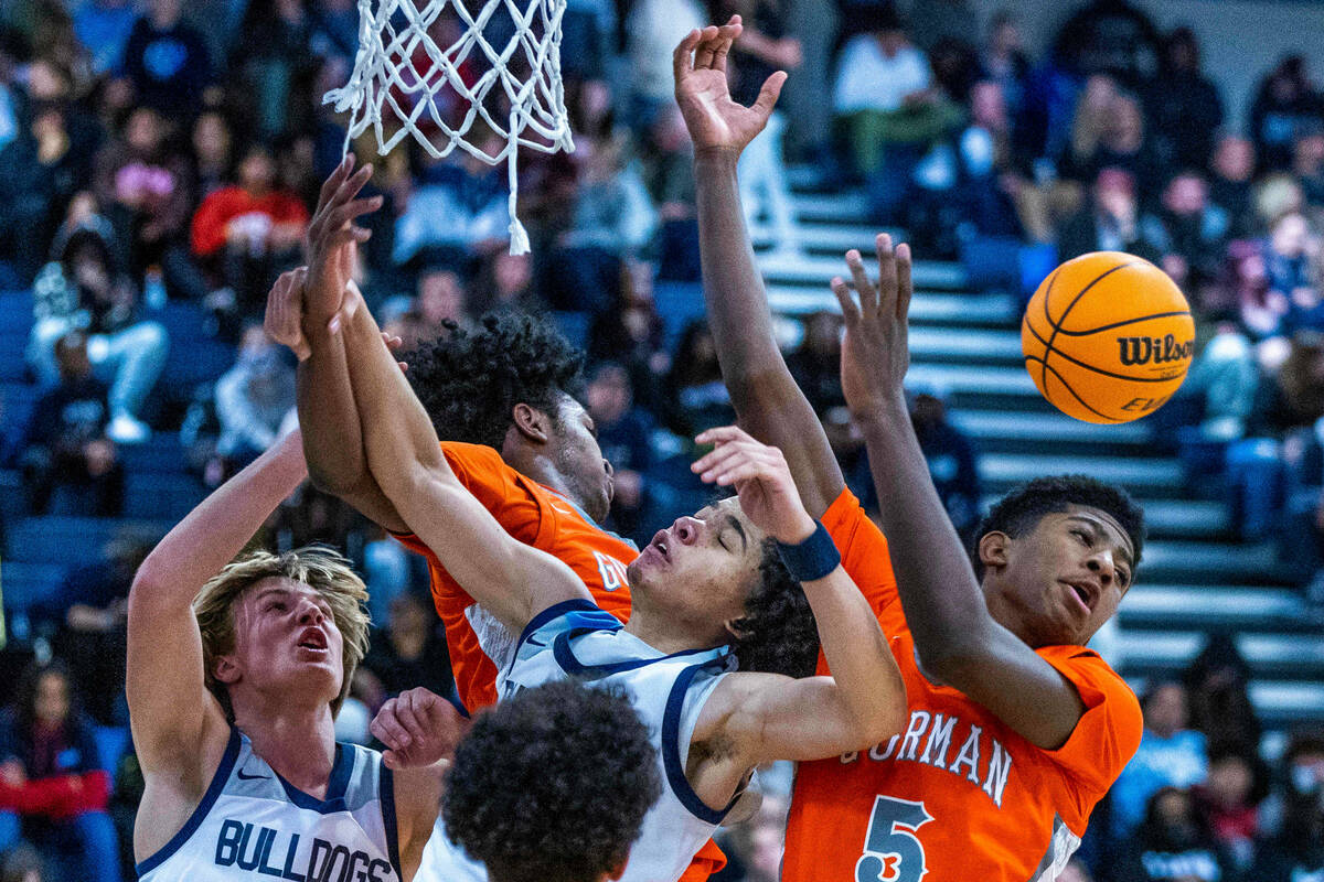 Bishop Gorman guard Jaxon Richardson (5) looks to a loose ball after colliding with Centennial ...