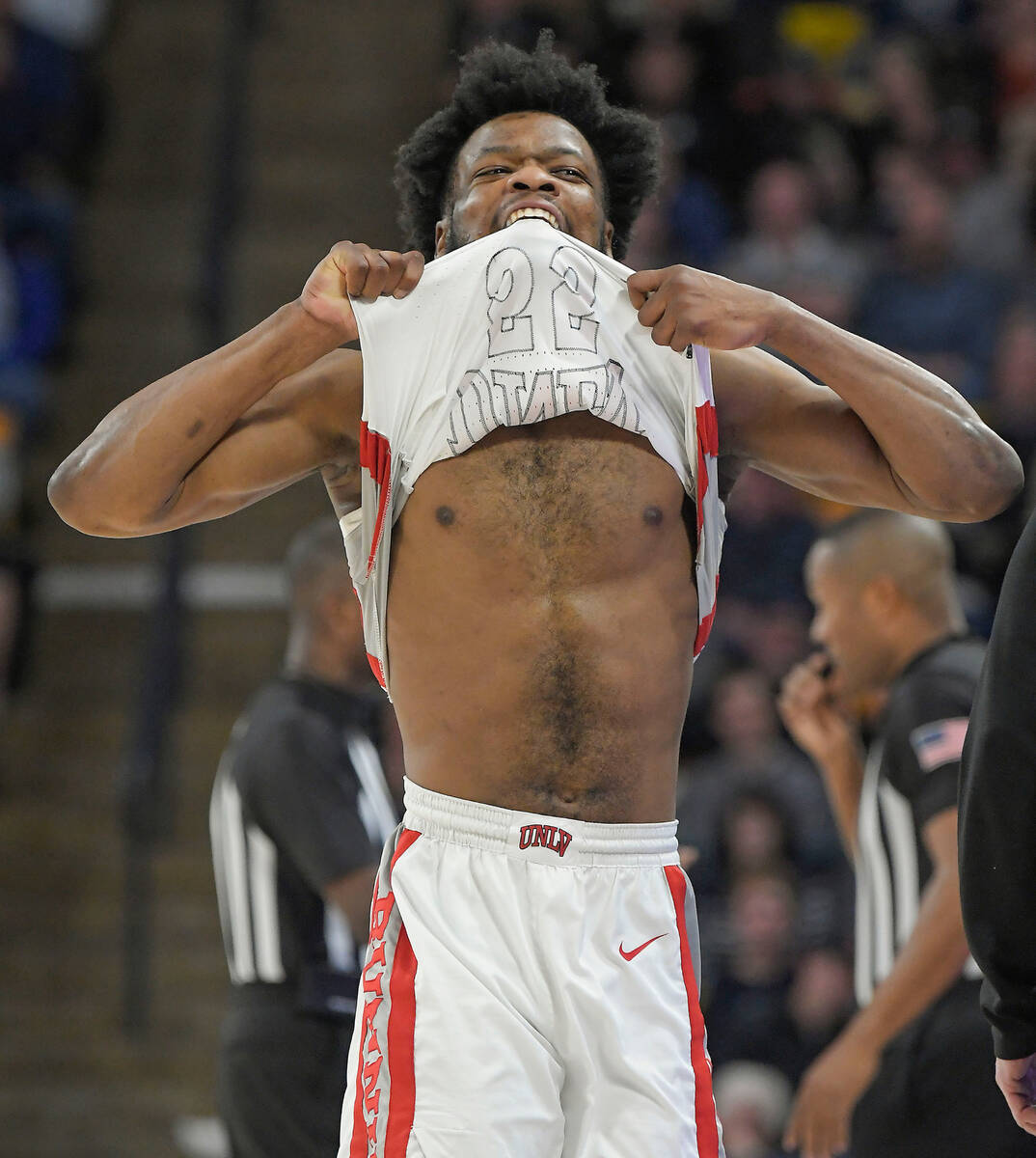 UNLV guard EJ Harkless reacts after mistakenly thinking he fouled out against Utah State during ...