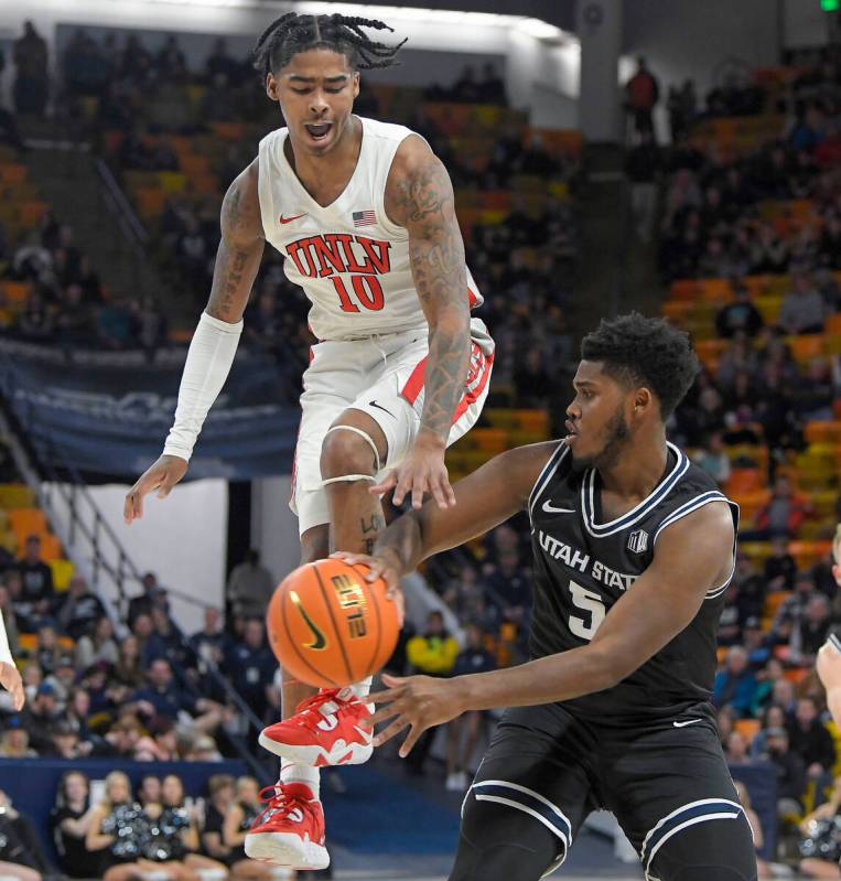 Utah State guard RJ Eytle-Rock (5) passes the ball as UNLV guard Keshon Gilbert (10) defends du ...