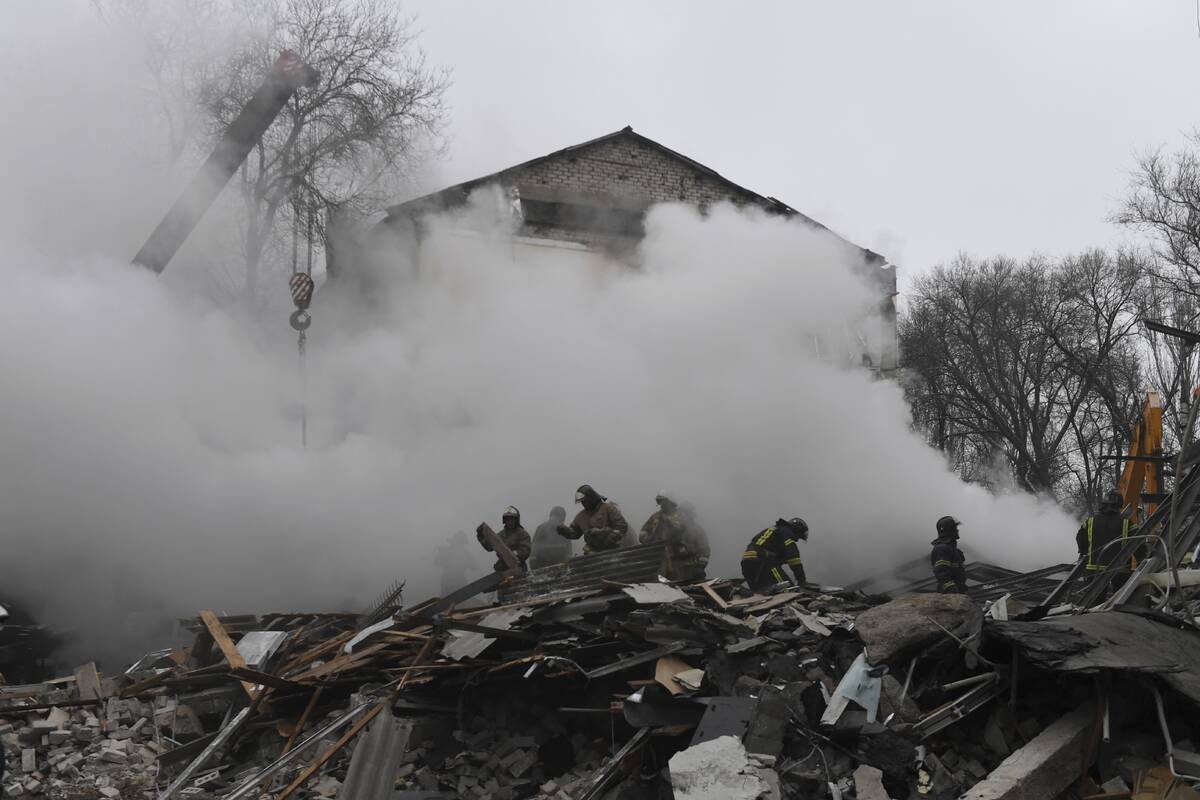 Donetsk's emergency employees work at a site of a shopping center destroyed after what Russian ...