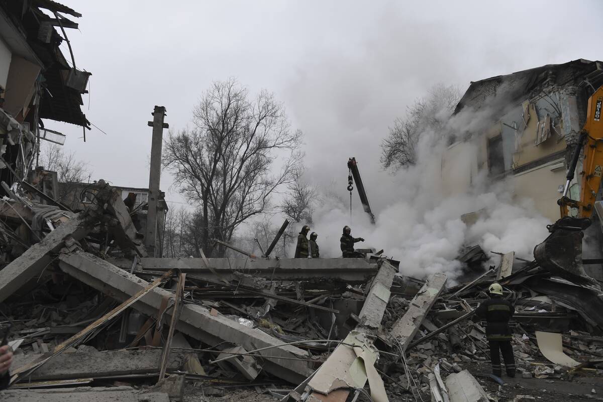 Smoke rises as Donetsk's emergency employees work at a site of a shopping center destroyed afte ...