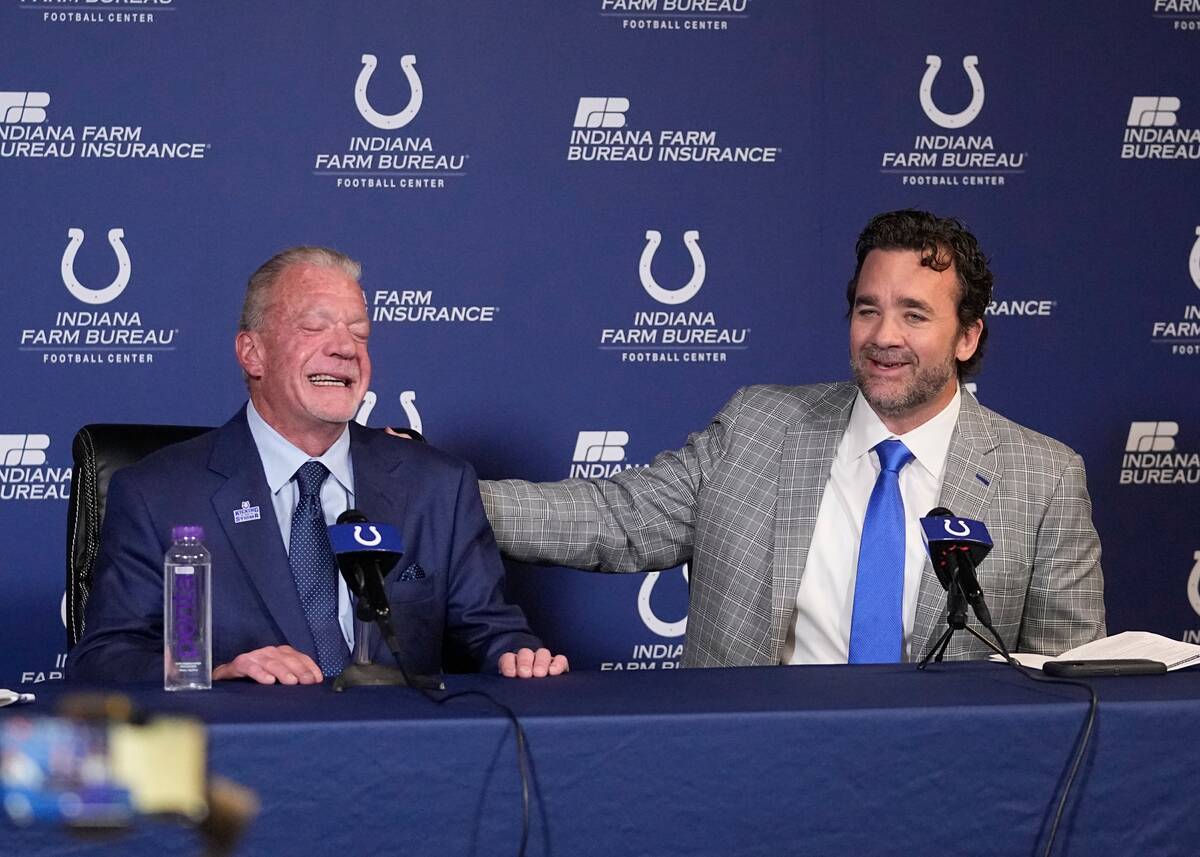 Indianapolis Colts interim coach Jeff Saturday speaks while team owner Jim Irsay listens during ...