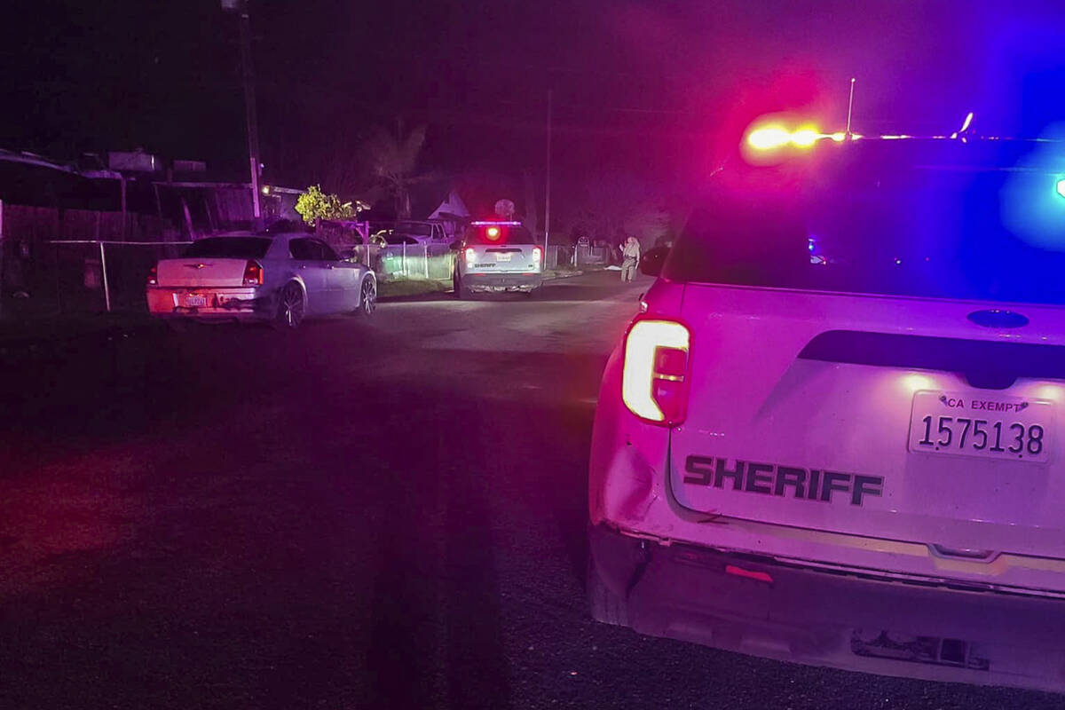 In this image released by Tulare County Sheriff's Office, detectives investigate a shooting in ...