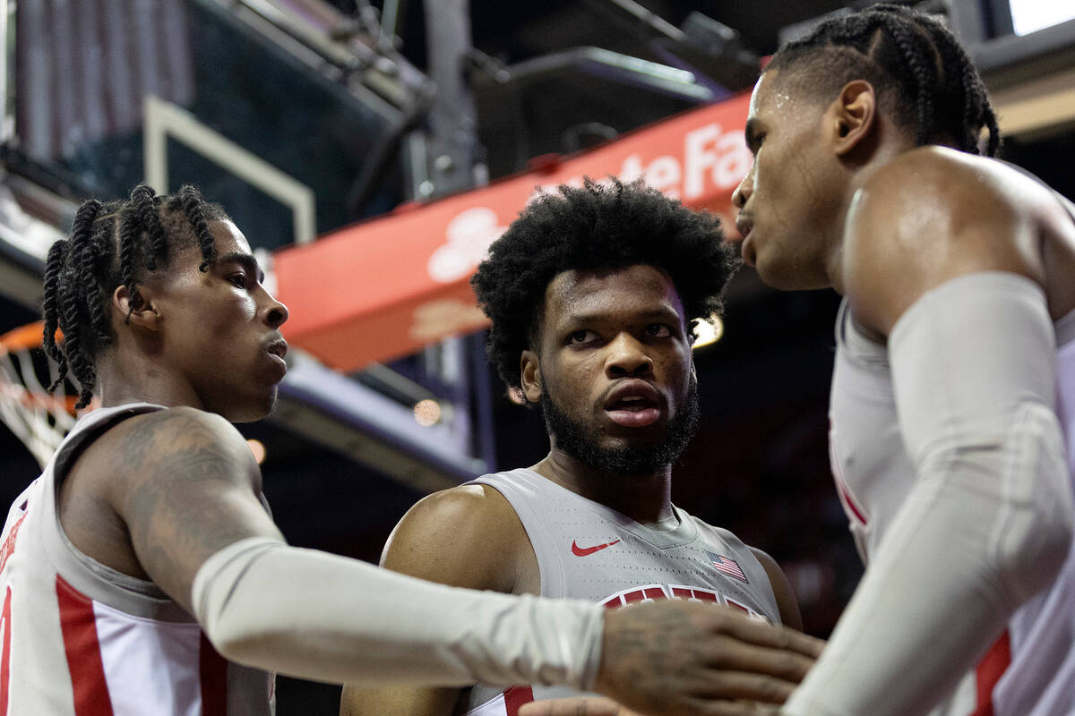 UNLV Rebels guard Keshon Gilbert (10), guard EJ Harkless, center, and guard Luis Rodriguez slap ...