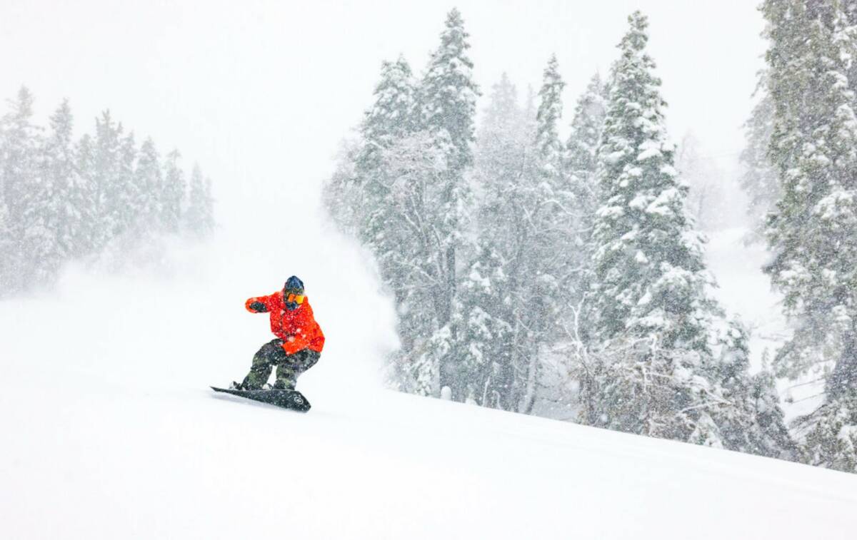 A snowboarder slides in Big Bear Mountain Ski resort in Big Bear Lake, Calif., Sunday, Jan. 15, ...