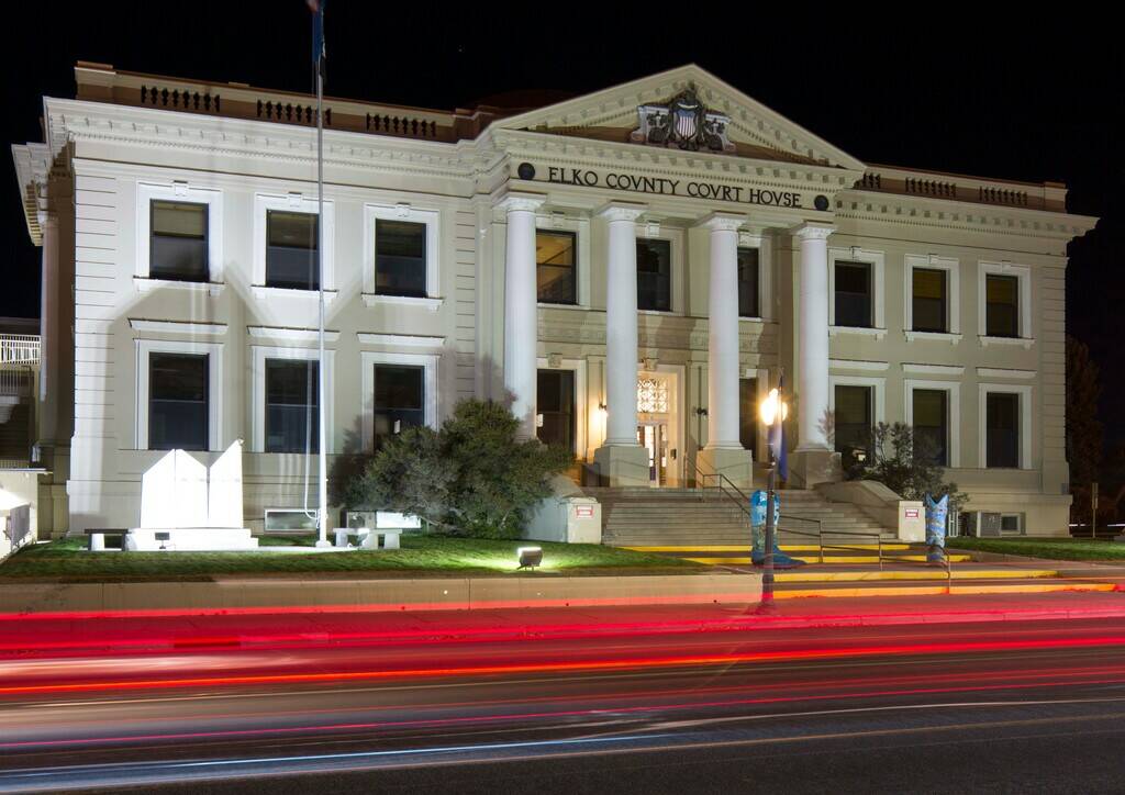 Cars leave trails of light as they pass the Elko County Court House in Elko, on Friday, Oct. 19 ...
