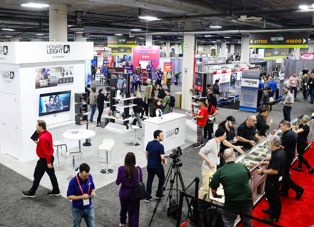 Attendees walk the showroom floor during the Shooting, Hunting and Outdoors trade show at the V ...