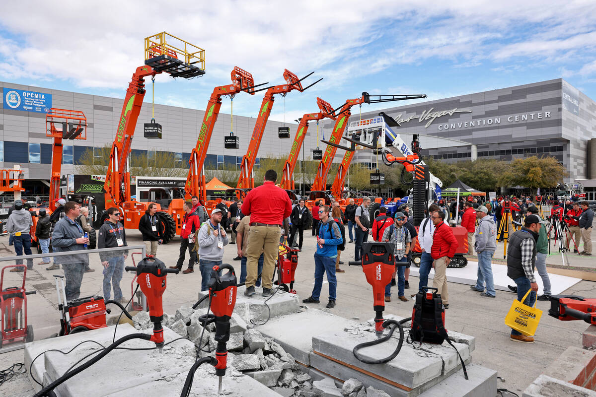 Hilti, Inc. representative Chase Ficklin demonstrates jackhammers in the Hilti booth on Day 1 o ...