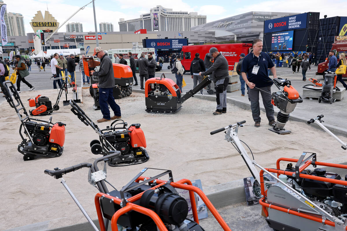 Representatives demonstrate equipment in the Husqvarna booth on Day 1 of World of Concrete at t ...