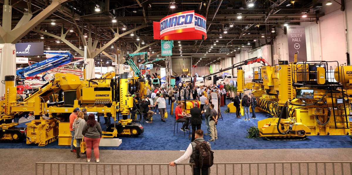 Conventioneers check out equipment in the Gomaco booth on Day 1 of World of Concrete at the Las ...